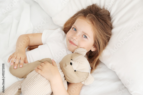 Adorable little girl huggin...