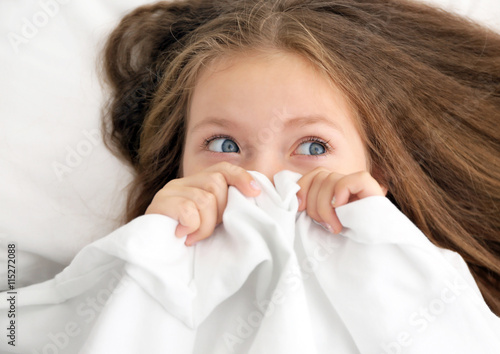 Cute little girl hiding und...