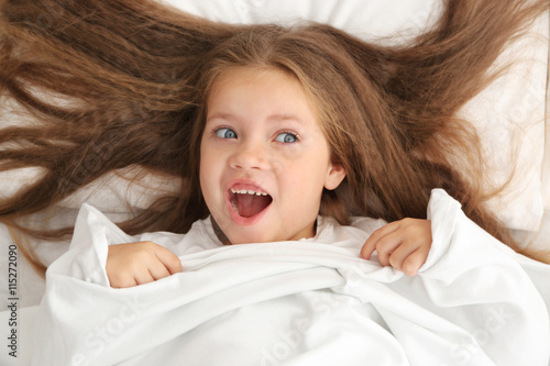 Cute little girl hiding und...