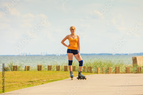 Young woman rollerblading outdoor on sunny day