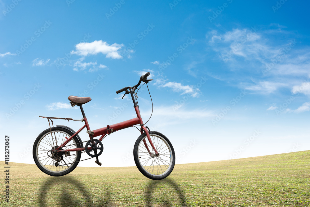 Bike on grass sky background.