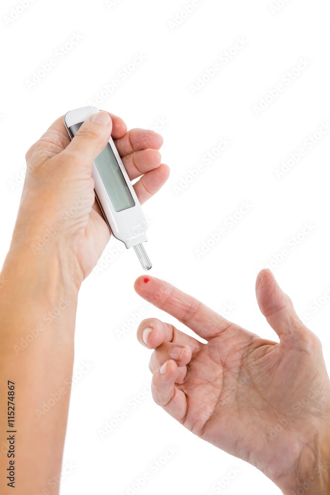 Cropped image of woman using blood glucose monitor Cropped image of woman using blood glucose monitor