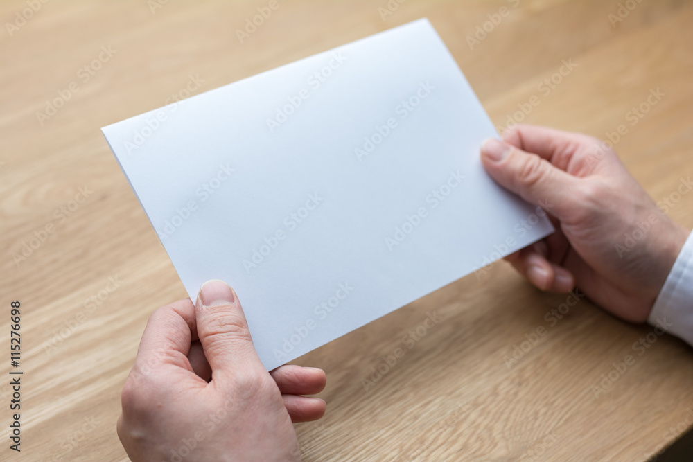 businessman holding white blank paper businessman holding white blank paper