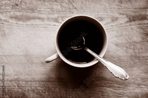 Horizontal cup with spoon bokeh background