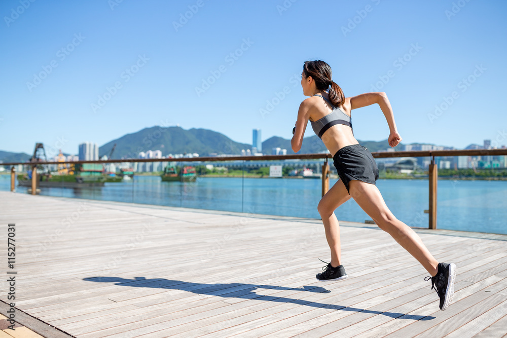 Woman running at boardwalk