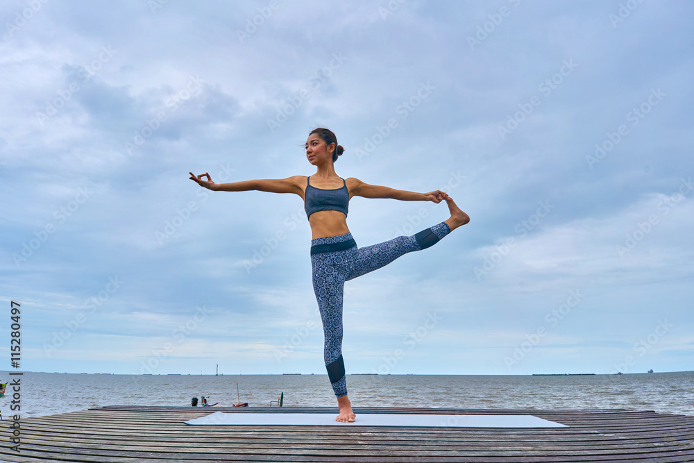Thai woman professional yoga trainer poses in outdoor location in Thailand. Thai woman professional yoga trainer poses in outdoor location in Thailand.