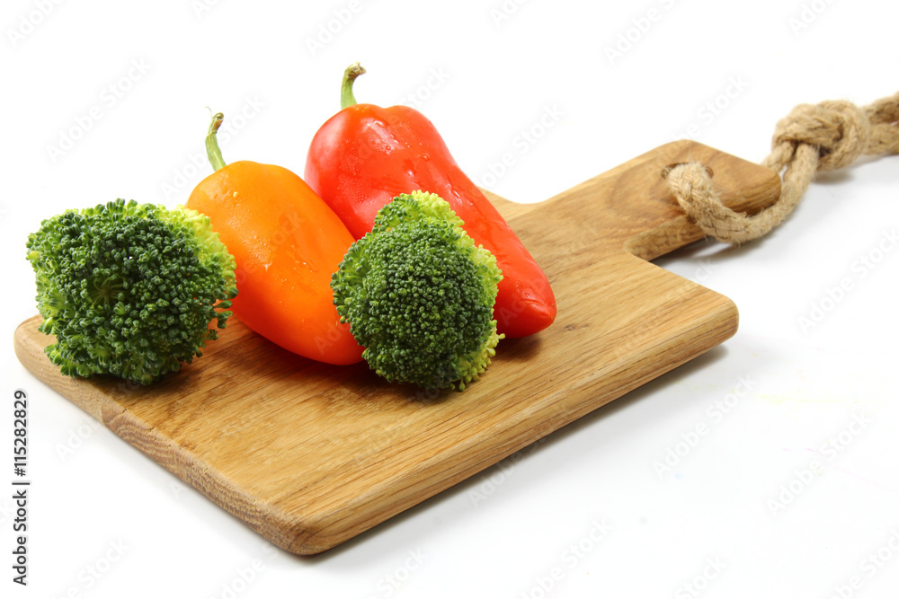 A cutting board with vegetables