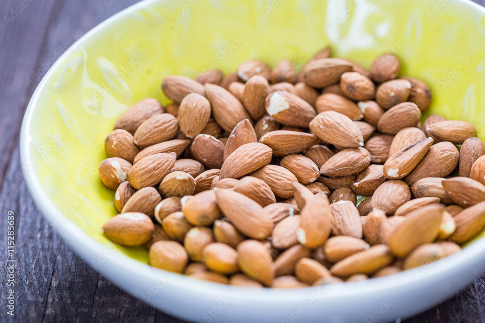 Almonds in Yellow Bowl on Dark Wooden Background, Healthy Food, Paleo Food Almonds in Yellow Bowl on Dark Wooden Background, Healthy Food, Paleo Food