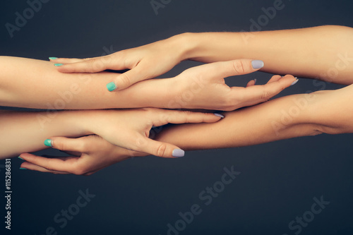 four female hands touching