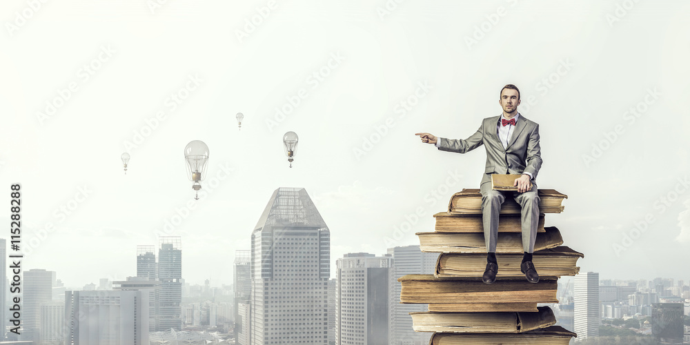 Businessman with old book . Mixed media Businessman with old book . Mixed media