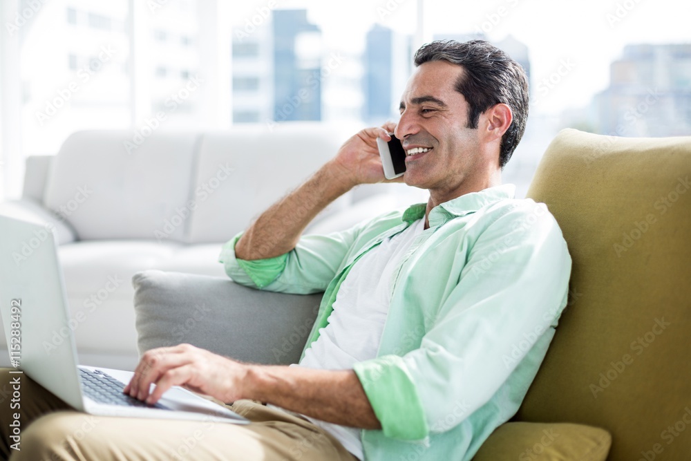 Man talking on cellphone at home Man talking on cellphone at home