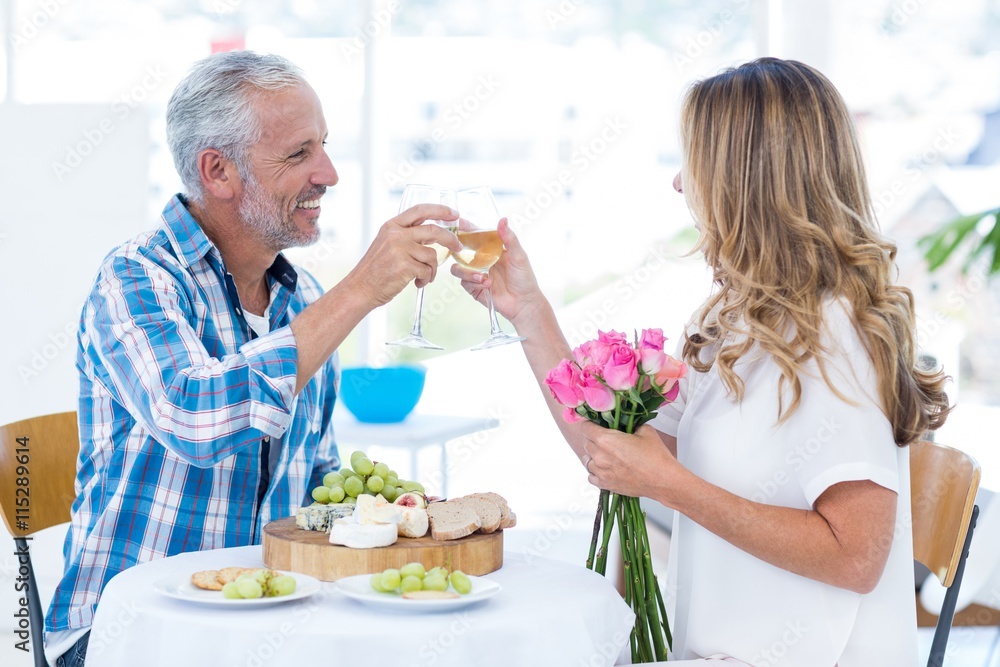 Mature couple toasting wineglass in restaurant
