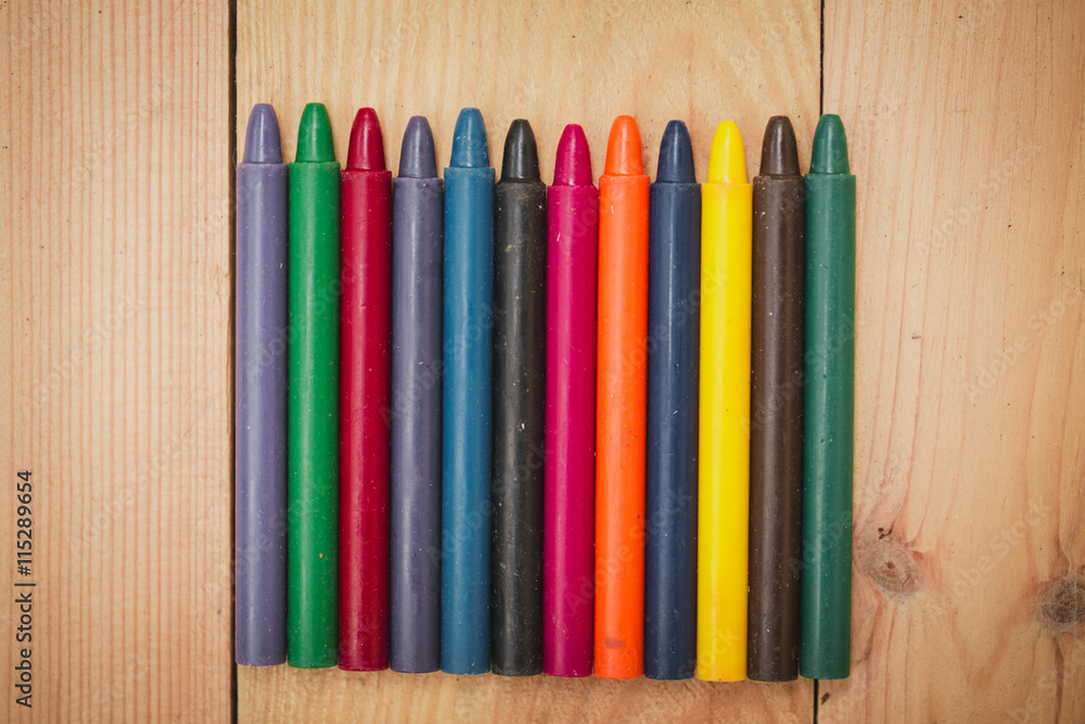 Fototapeta premium Crayon on wood background with copy space