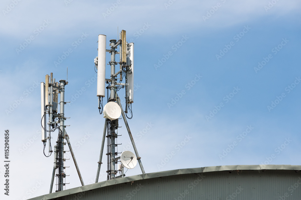 Close up white color antenna repeater tower on blue sky Close up white color antenna repeater tower on blue sky