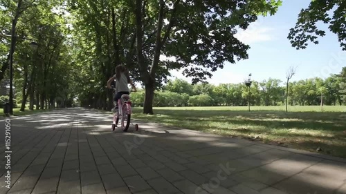 Wallpaper Mural Happy girl riding bike in the park Torontodigital.ca