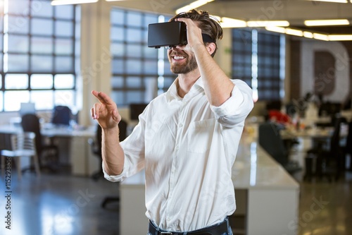 Businessman smiling while using virtual reality simulator