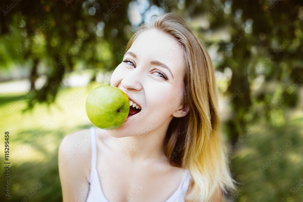 gren apples.smiling woman with apple, outdoors, Healthy eating concept.Close up gren apples.smiling woman with apple, outdoors, Healthy eating concept.Close up