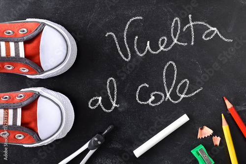 Vuelta al cole written on a blackboard with tools photo