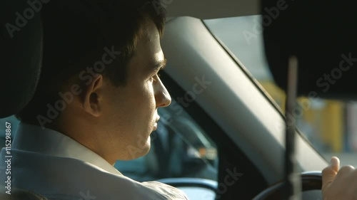 Man drinking water in the car