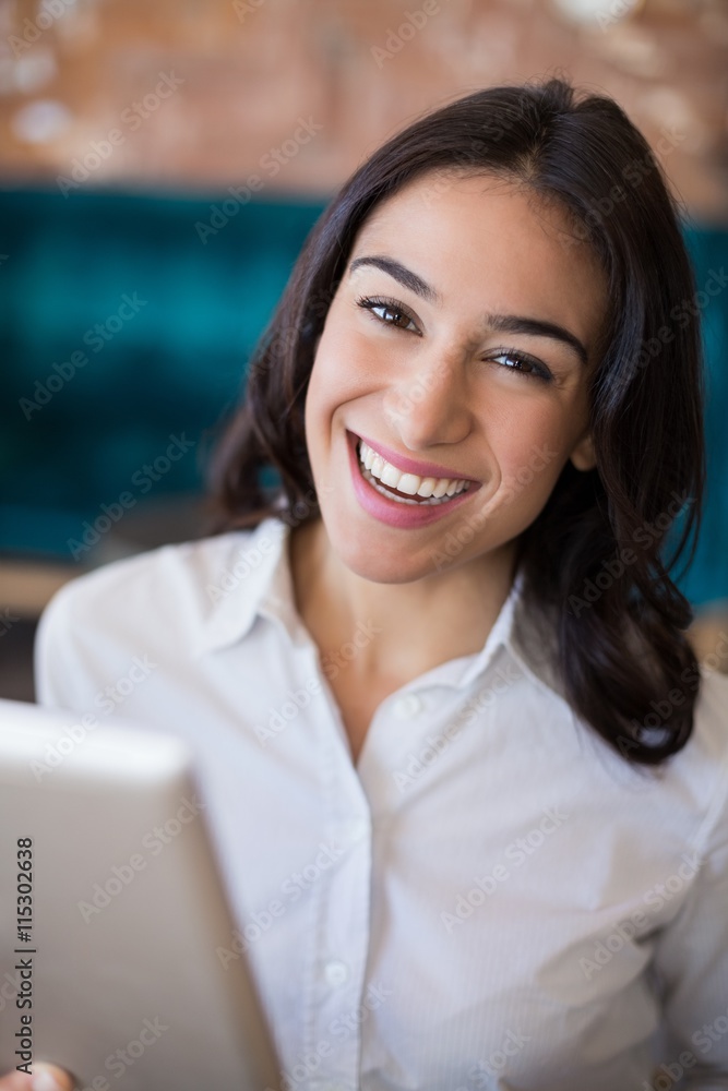 Businesswoman using digital tablet in café Businesswoman using digital tablet in café