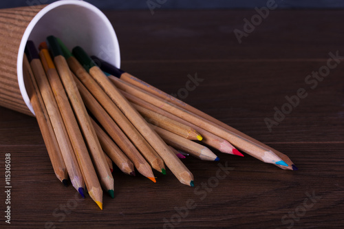 Coloured pencils on a worn black background photo