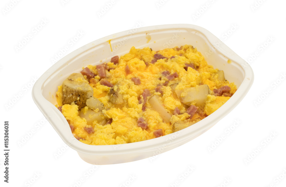 Ham eggs and potatoes breakfast TV dinner in a tray isolated on a white background.