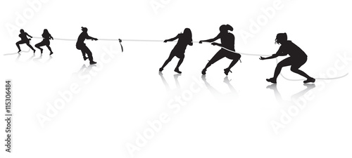 Young females pulling a rope in tug of war with reflection photo