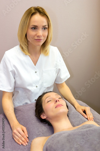 Young attractive blond beautician woman preparing a facial massa