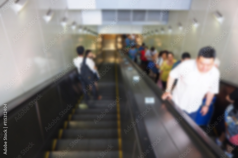 Blurred abstract background of People using escalator