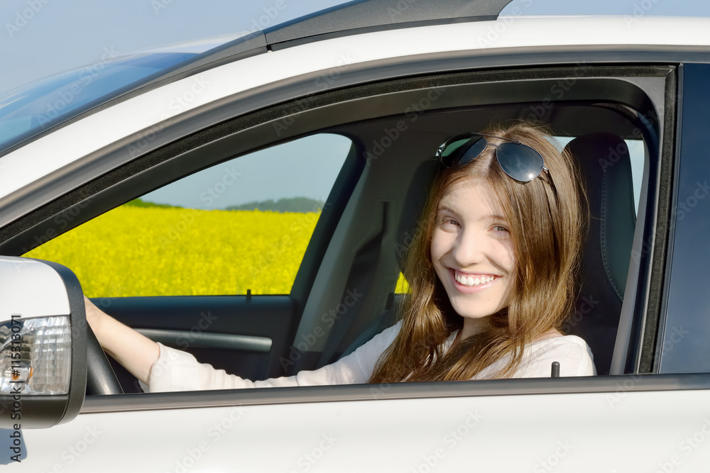 Happy Teenage Female Driver in her Car