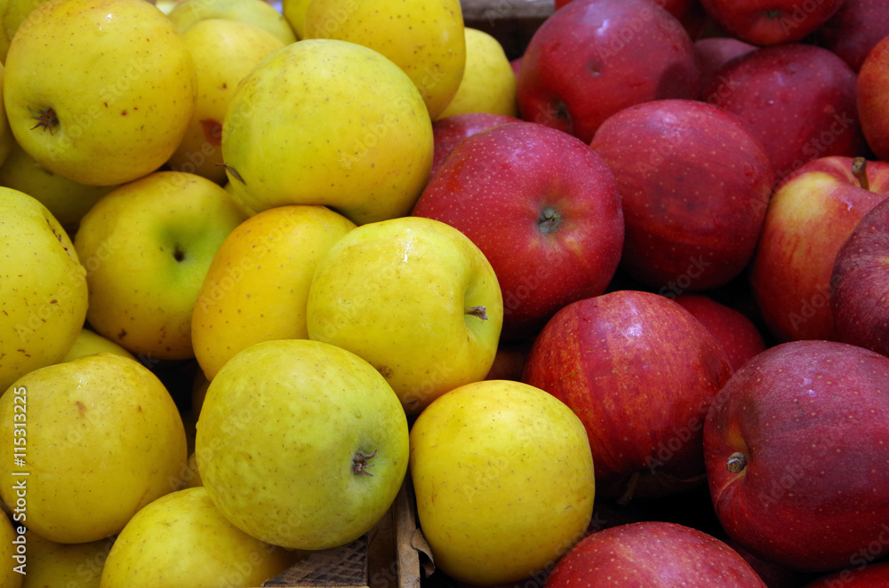 Yellow and red apples mixing in crates at market place Yellow and red apples mixing in crates at market place