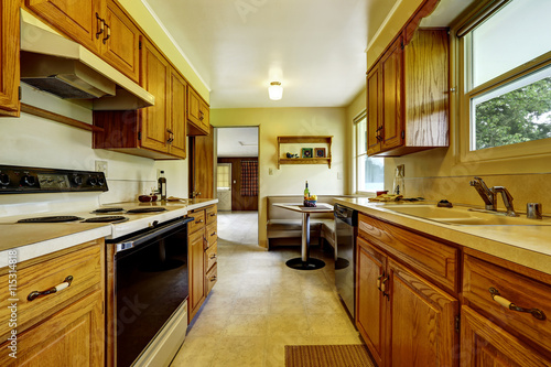 Light narrow kitchen room with corner sofa and small table