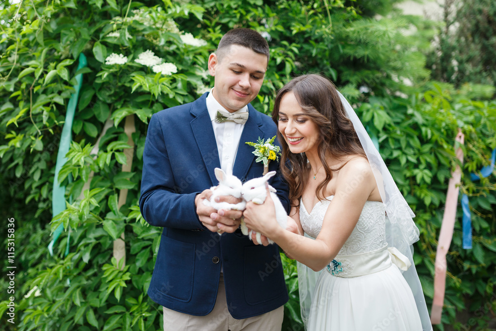 Wedding couple with two small rabbits Wedding couple with two small rabbits
