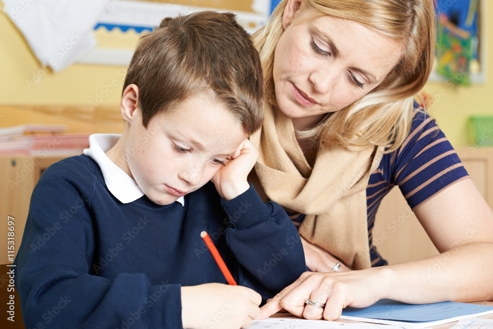 Teacher With Male Elementary School Pupil With Problem Teacher With Male Elementary School Pupil With Problem