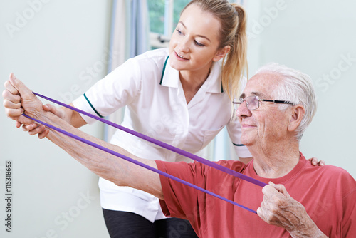 Senior Male Working With Physiotherapist photo