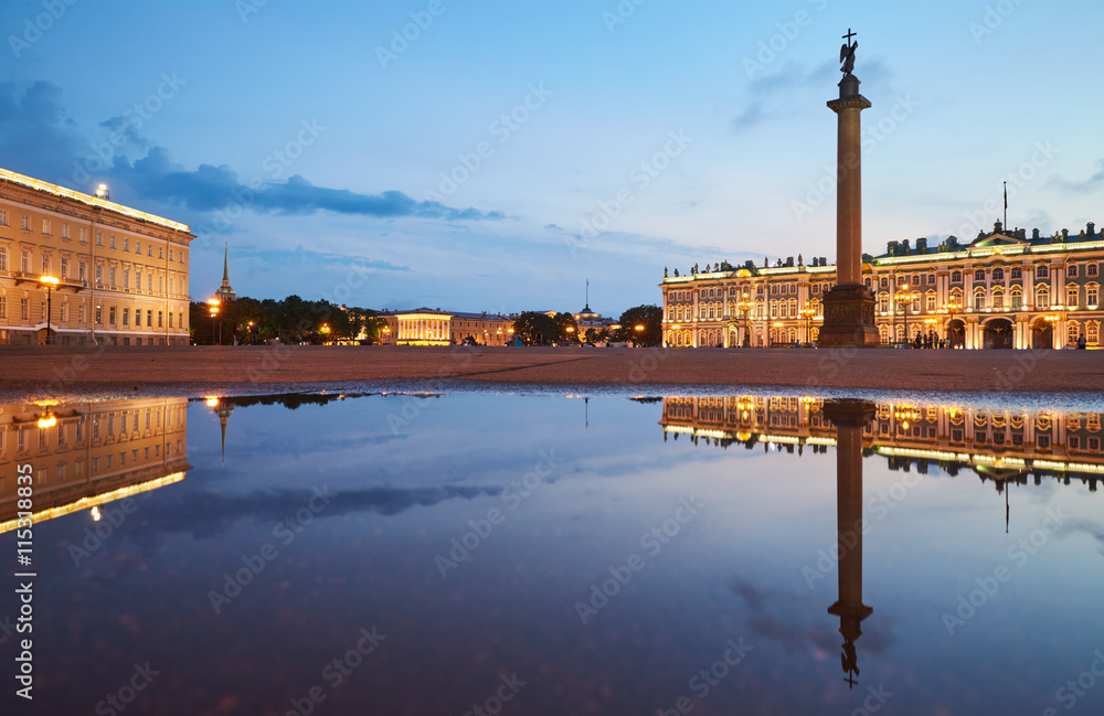 Russia, Saint-Petersburg, 03 July 2016: Palace Square with night illumination, Winter Palace, Hermitage, Alexander Column, reflection in a water pool after a rain, a lot tourists, sunset, water mirror