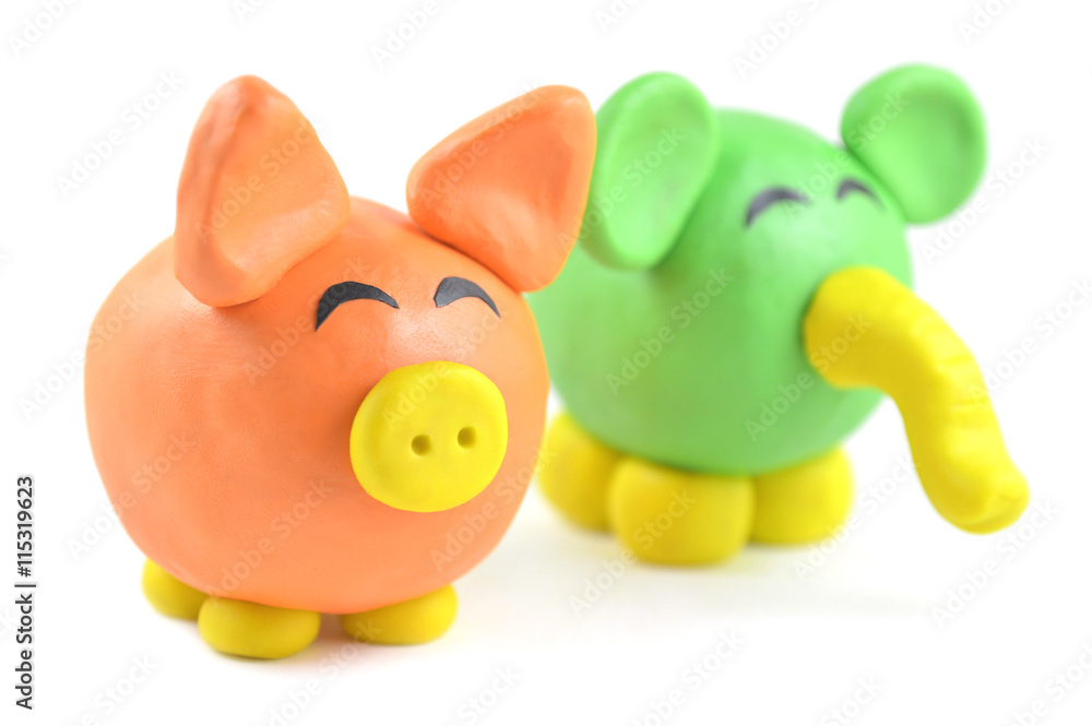 Plasticine pig and elephant on white background Plasticine pig and elephant on white background