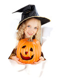 blonde girl holding pumpkin in witch costume