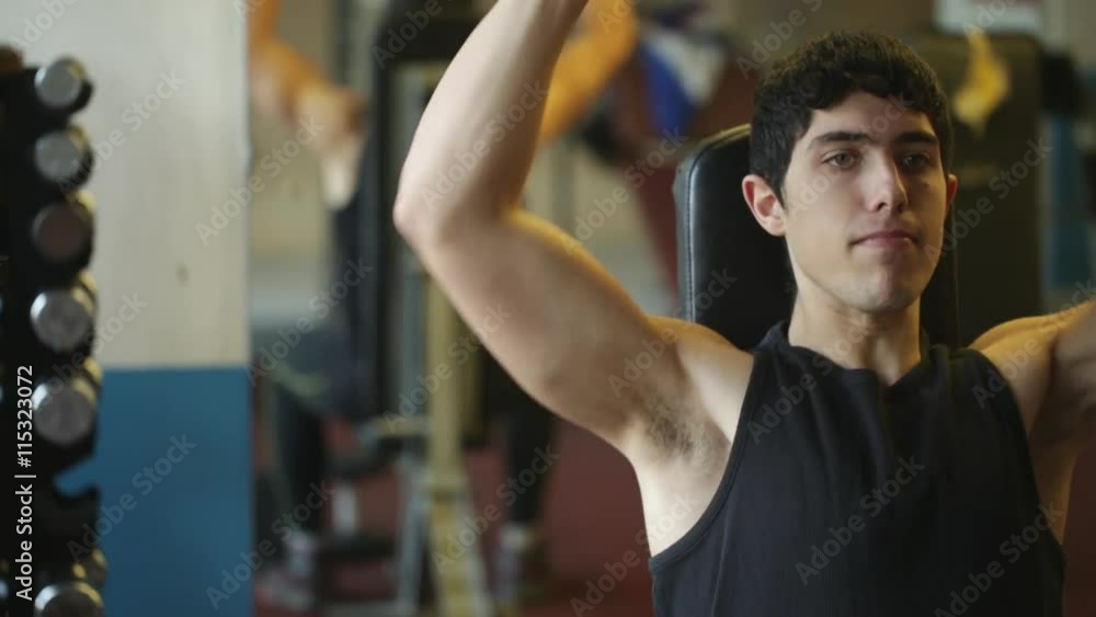 Young fitness man doing dumbell workout in gym. Young fitness man doing dumbell workout in gym.
