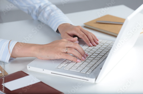 Young pretty business woman with notebook in the office