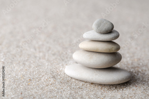 Japanese zen garden meditation stone for concentration and relaxation sand and rock for harmony and balance in pure simplicity - macro lens shot