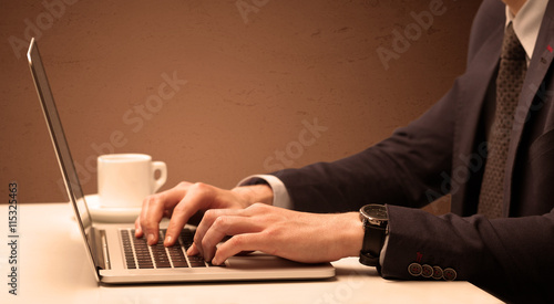 Businessman is suit working on laptop