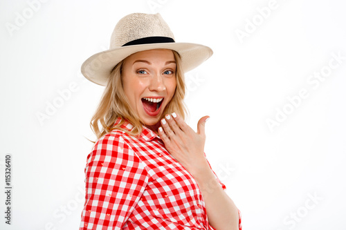 Portrait of beautiful country girl surprised over white background.