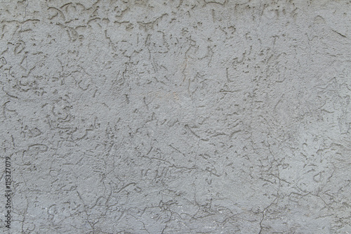 Grey rugged plaster as background texture