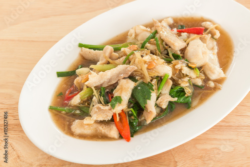Stir-fried fish with Chinese celery in white dish (Thai food)