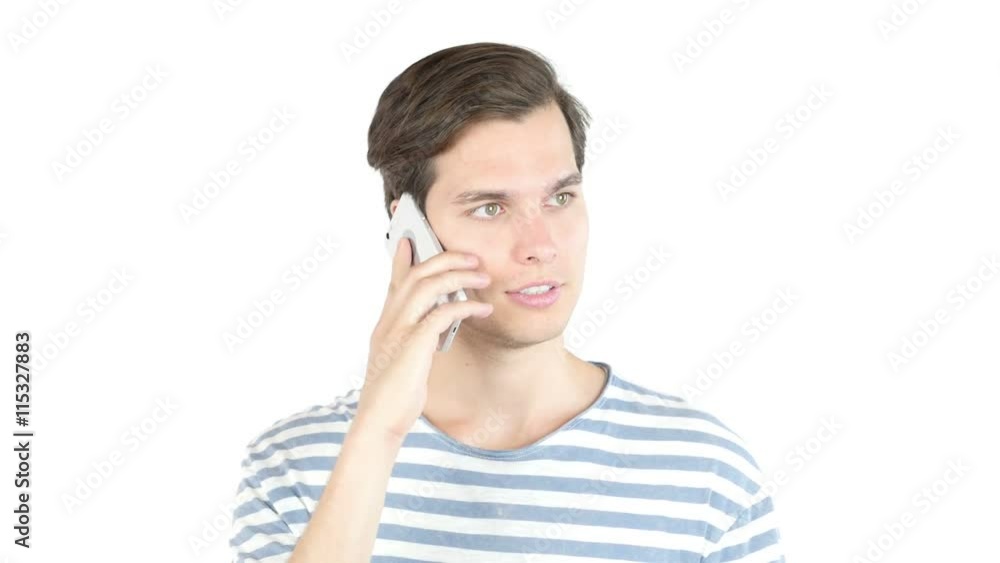 Attractive young man laughing talking on phone , isolated white background Attractive young man laughing talking on phone , isolated white background