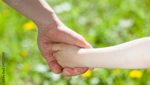 Child holding father's hand © zest_marina