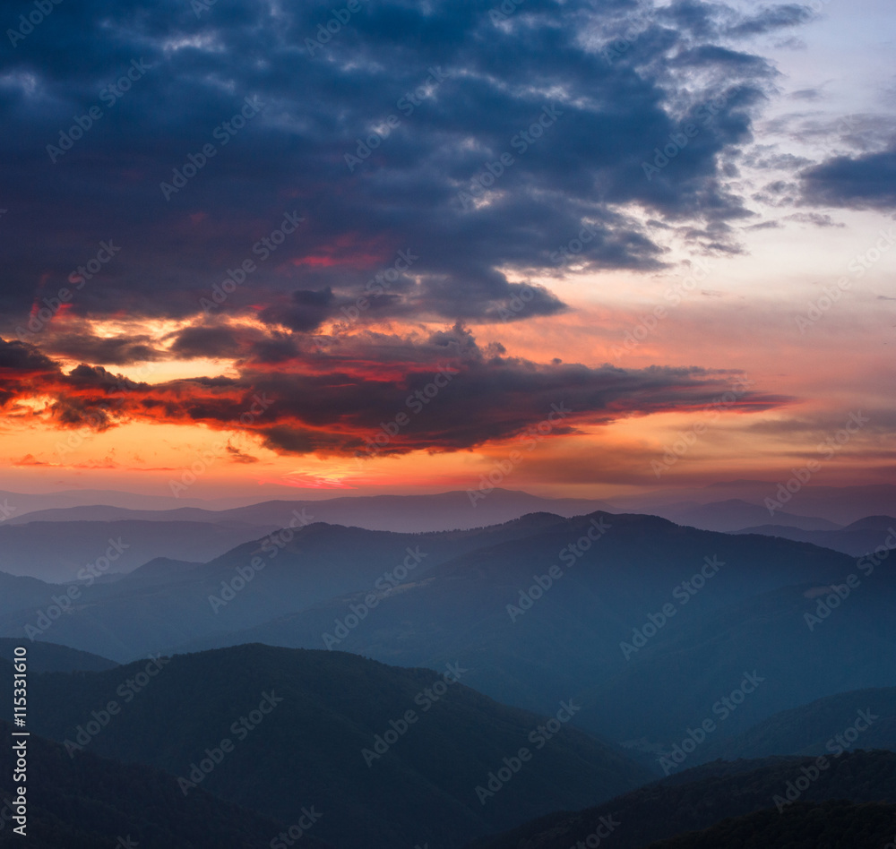 Beautiful  panoramic sunset in the mountains landscape. Dramatic evening sky.