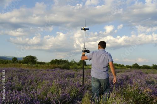 Surveyor walking in a lavender field photo