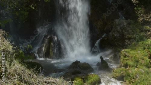 Lower part of the waterfall where the water smashes on the rocks, creating lots of water spray photo